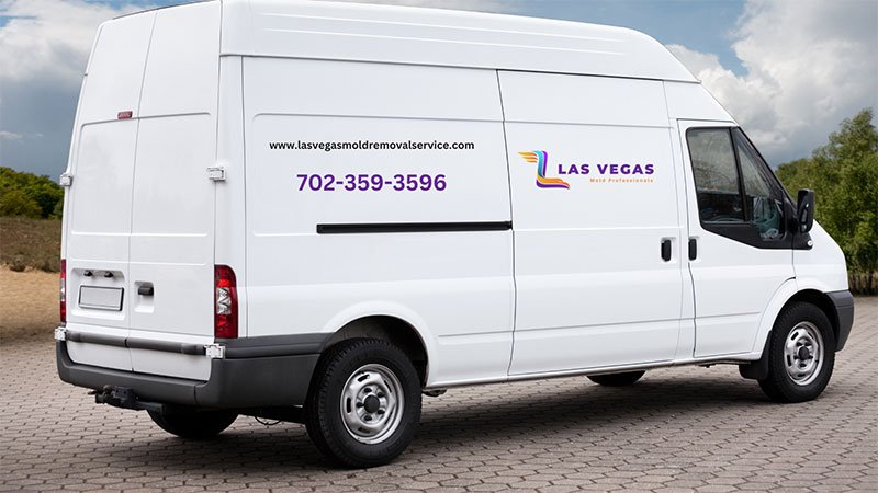 An exterior view of a Las Vegas, NV, home undergoing mold removal, with workers and equipment visible in the scene.